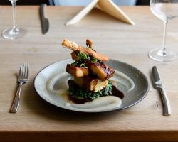 Slow braised belly of pork served with dauphinoise potato, buttered curly kale, apple cider purée, red wine jus and crispy crackling Slow braised belly of pork served with dauphinoise potato, buttered curly kale, apple cider purée, red wine jus and crispy crackling