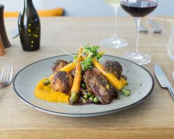 Pan roast 7oz lamb rump served with a shepherd’s pie croquette potato, sautéed bacon, peas and shallots, roasted carrot purée, baby carrots and a minted red wine jus Pan roast 7oz lamb rump served with a shepherd’s pie croquette potato, sautéed bacon, peas and shallots, roasted carrot purée, baby carrots and a minted red wine jus