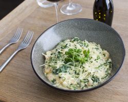 Mushroom and spinach risotto topped with Grana Padano Tipo cheese Mushroom and spinach risotto topped with Grana Padano Tipo cheese